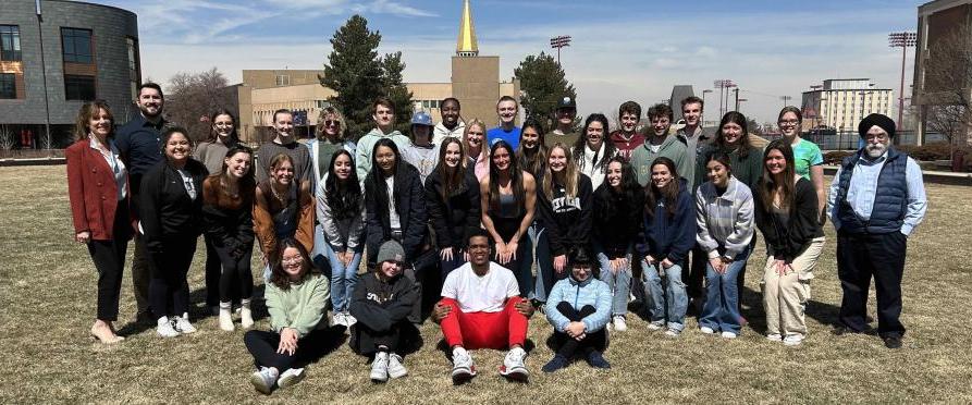 A group of students standing on Campus Green planning for the Langar@DU event